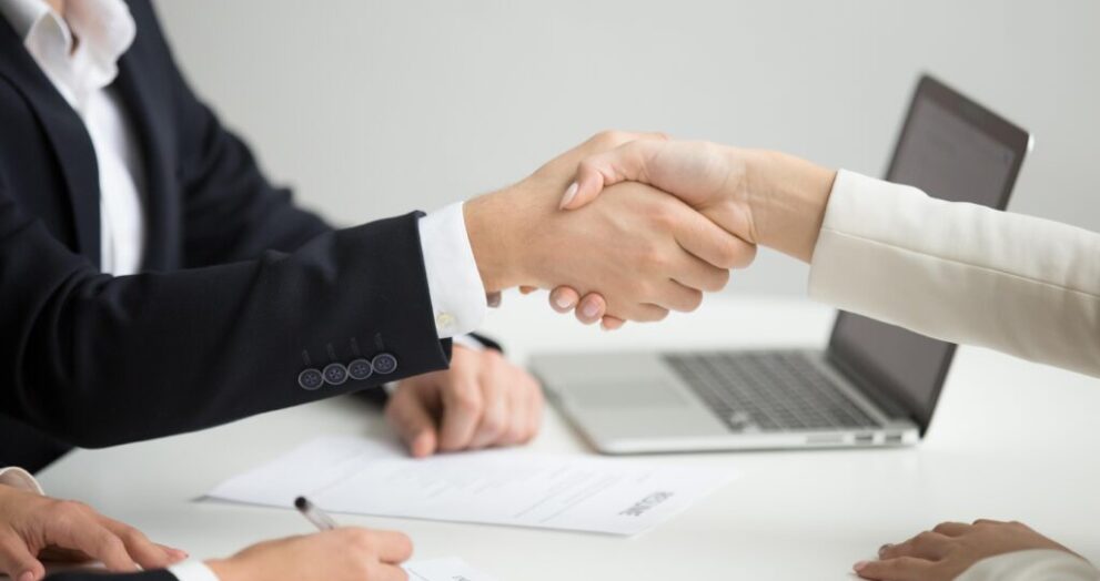 hr handshaking successful candidate getting hired new job closeup 1 1024x683