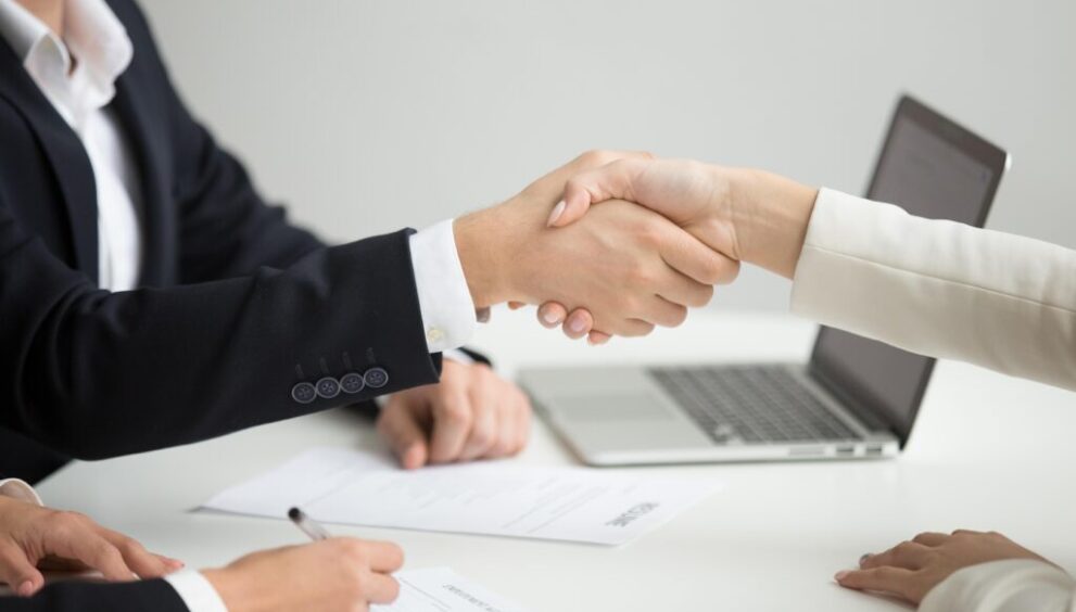 hr handshaking successful candidate getting hired new job closeup 1 1024x683